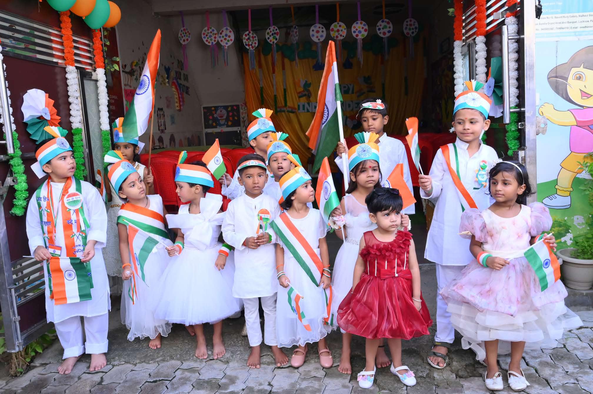 Children with flags outside the school