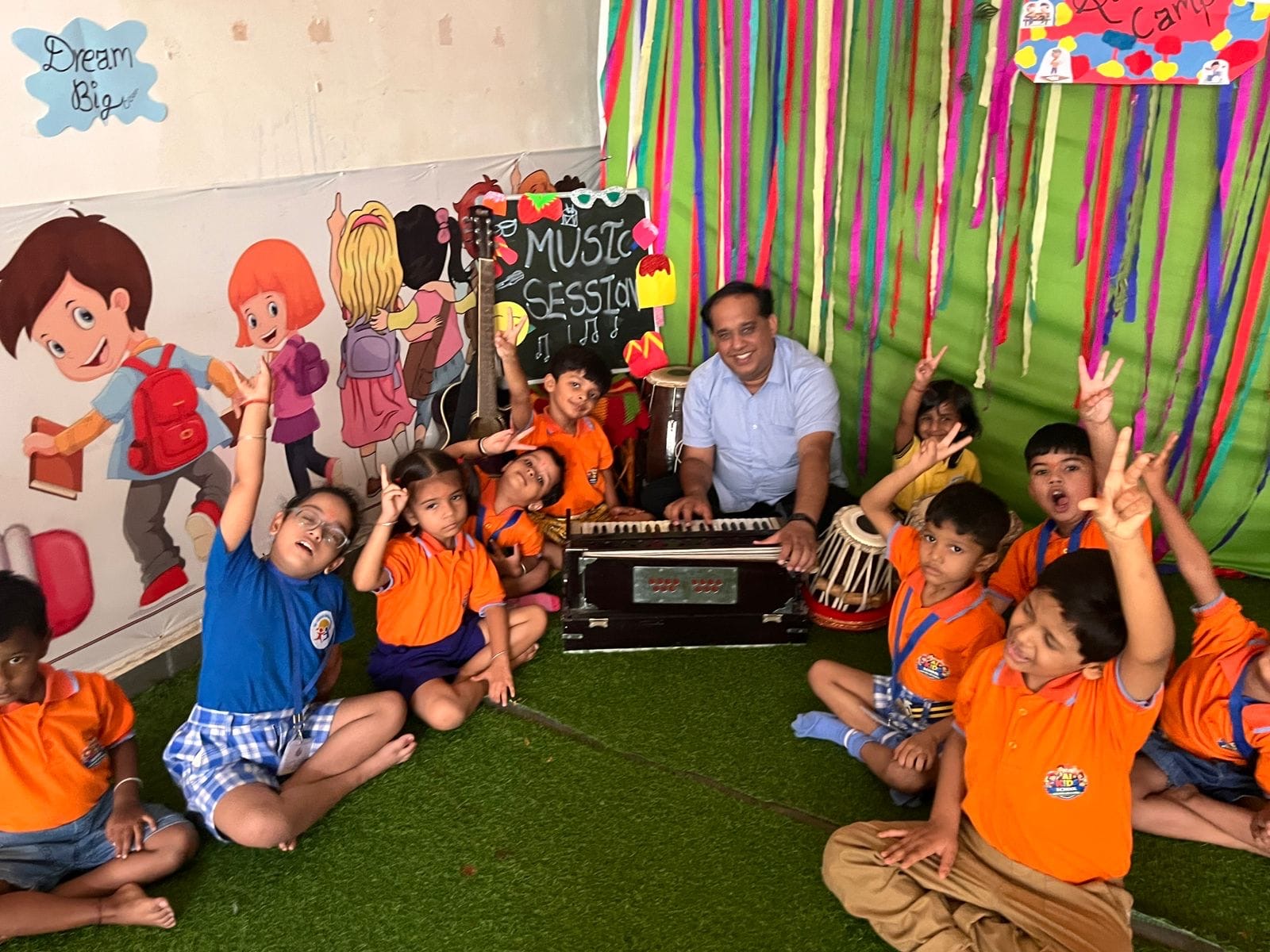 Children in a music session with their teacher at AI Kids School