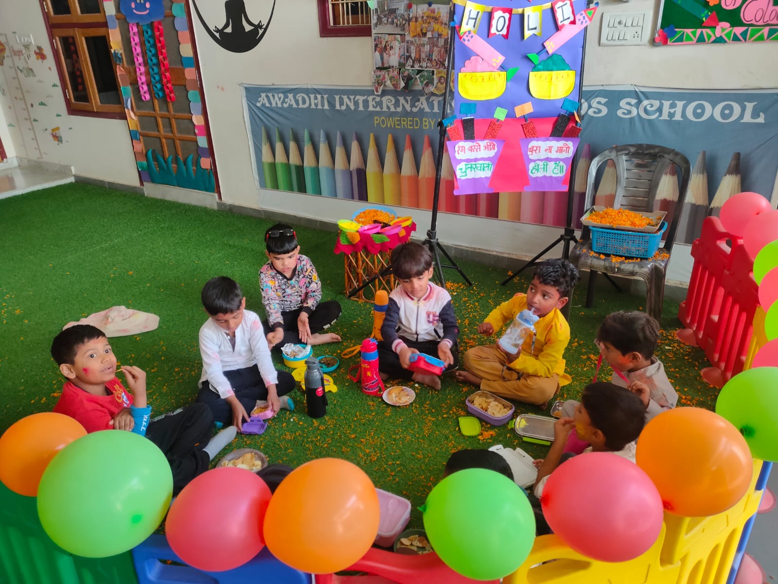Children playing with balloons on the soft-turf play area